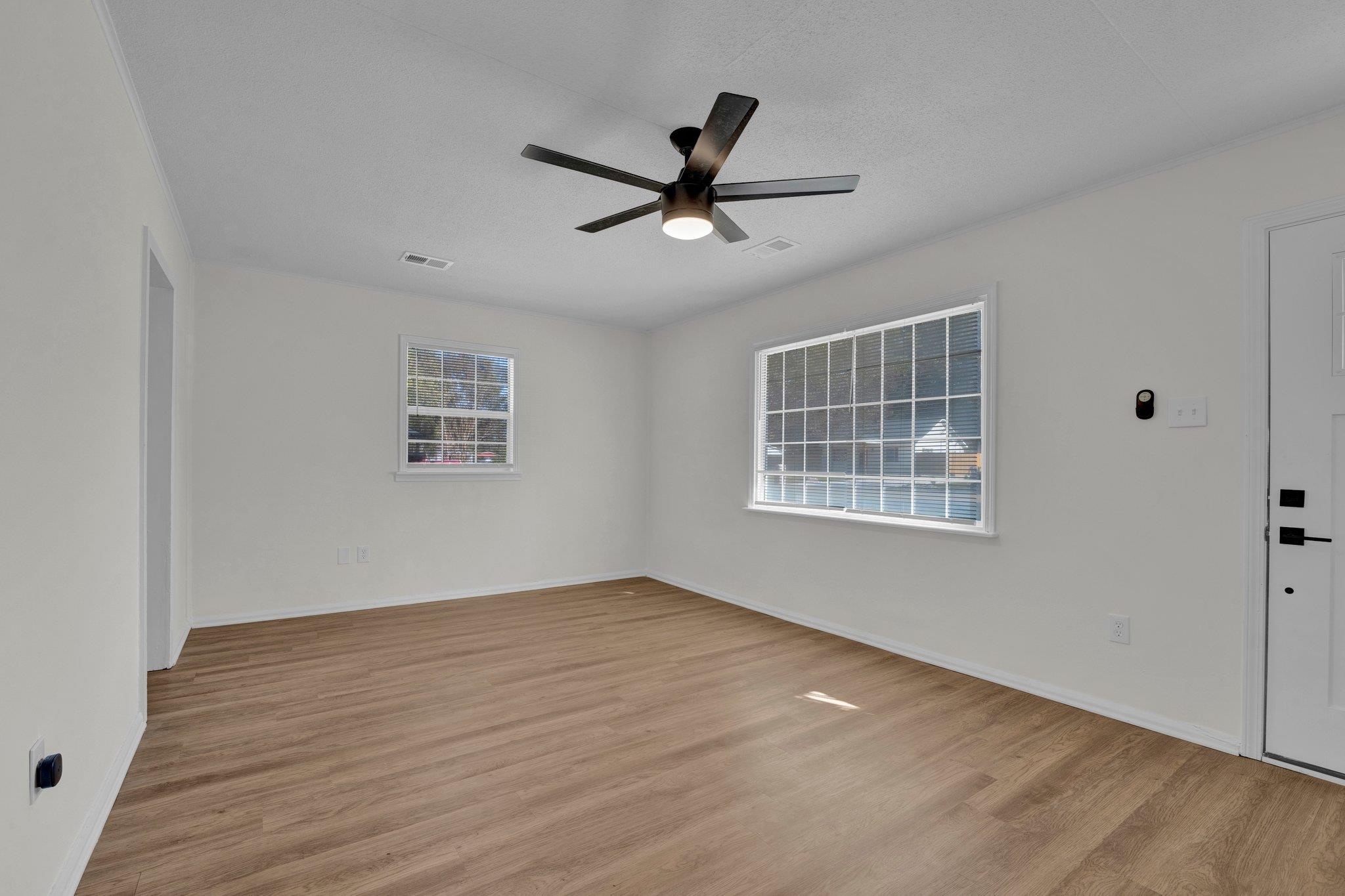 7829 Admiral Road Millington, TN 38053 - Photo 10 of 28 Empty room with light wood-type flooring, ceiling fan, and plenty of natural light