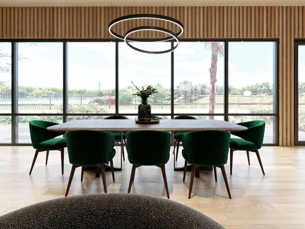 a dining room with furniture and large windows