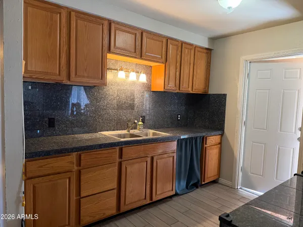 a kitchen with stainless steel appliances granite countertop a sink and cabinets