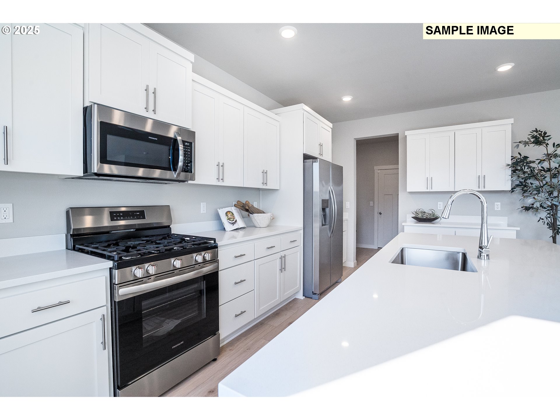 16698 Southwest Rubicon Lane Portland, OR 97224 - Photo 4 of 28 a kitchen with stainless steel appliances a stove a microwave and white cabinets