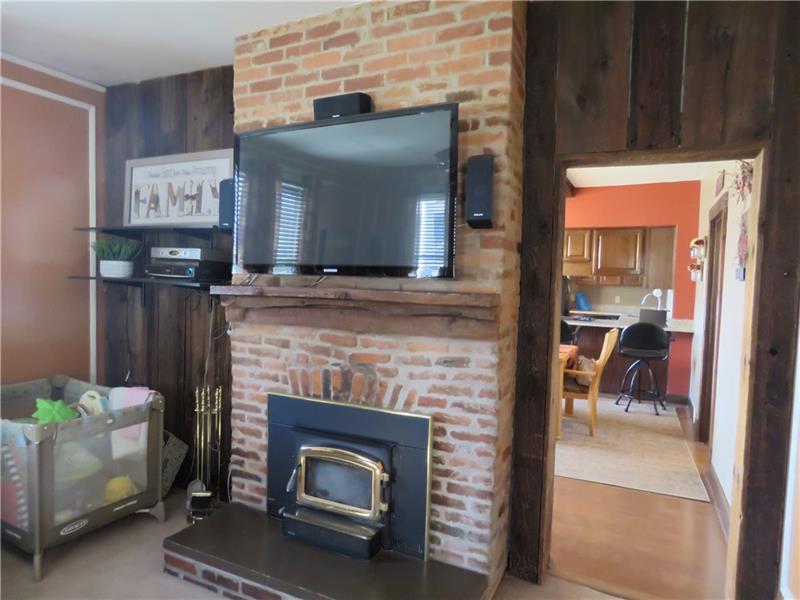 405 Soose Road Pittsburgh, PA 15209 - Photo 3 of 24 Exposed Brick Fireplace in Living Room adds Ambience
