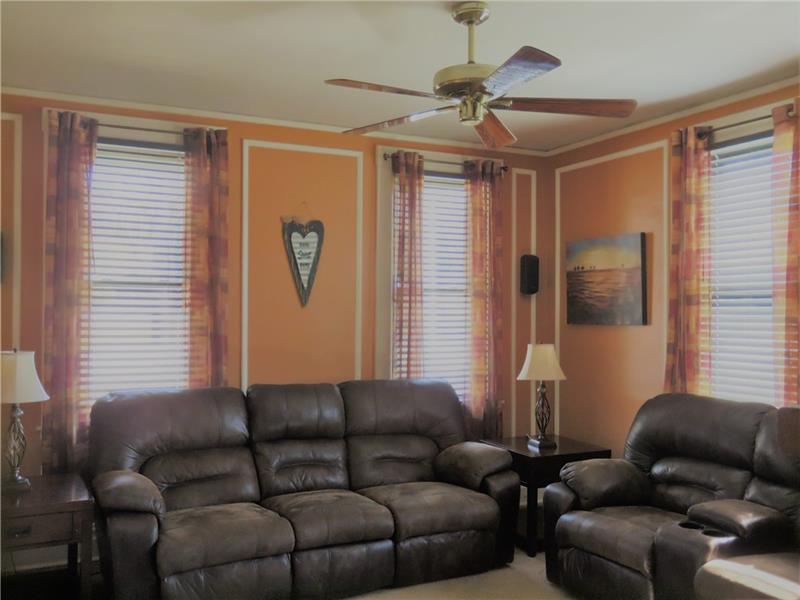 405 Soose Road Pittsburgh, PA 15209 - Photo 4 of 24 Living Room Painted with Warm Colors and Features a Ceiling Fan.