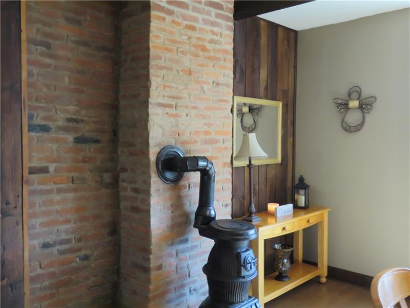 405 Soose Road Pittsburgh, PA 15209 - Photo 6 of 24 Exposed Brick Wall in Dining Room with Wood Burner