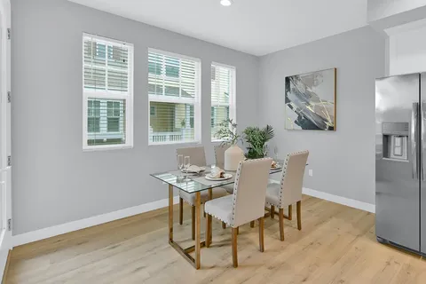 a spacious bedroom with a bed and painting on the wall