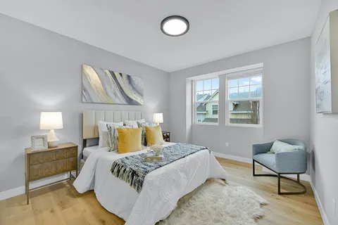 a bedroom with a bed and lamp