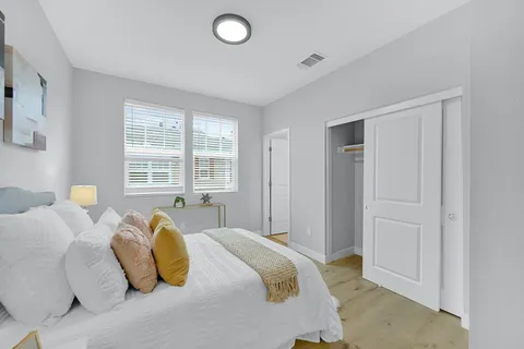a bedroom with a bed and a window