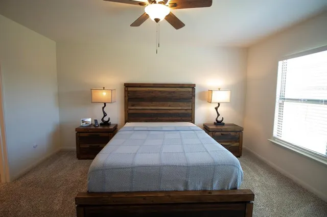 a bedroom with a bed and window