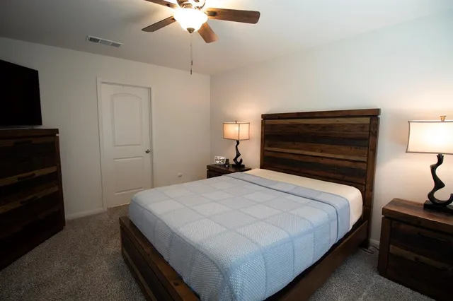 a bedroom with a bed and a chandelier