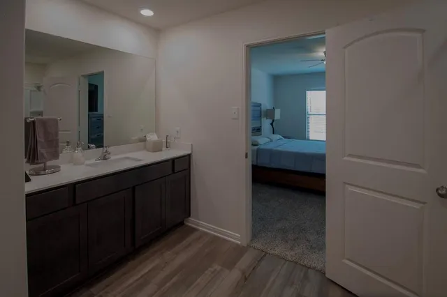 a en suite bathroom with a sink and mirror