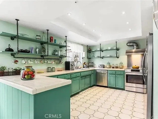 a kitchen with a sink a stove and cabinets