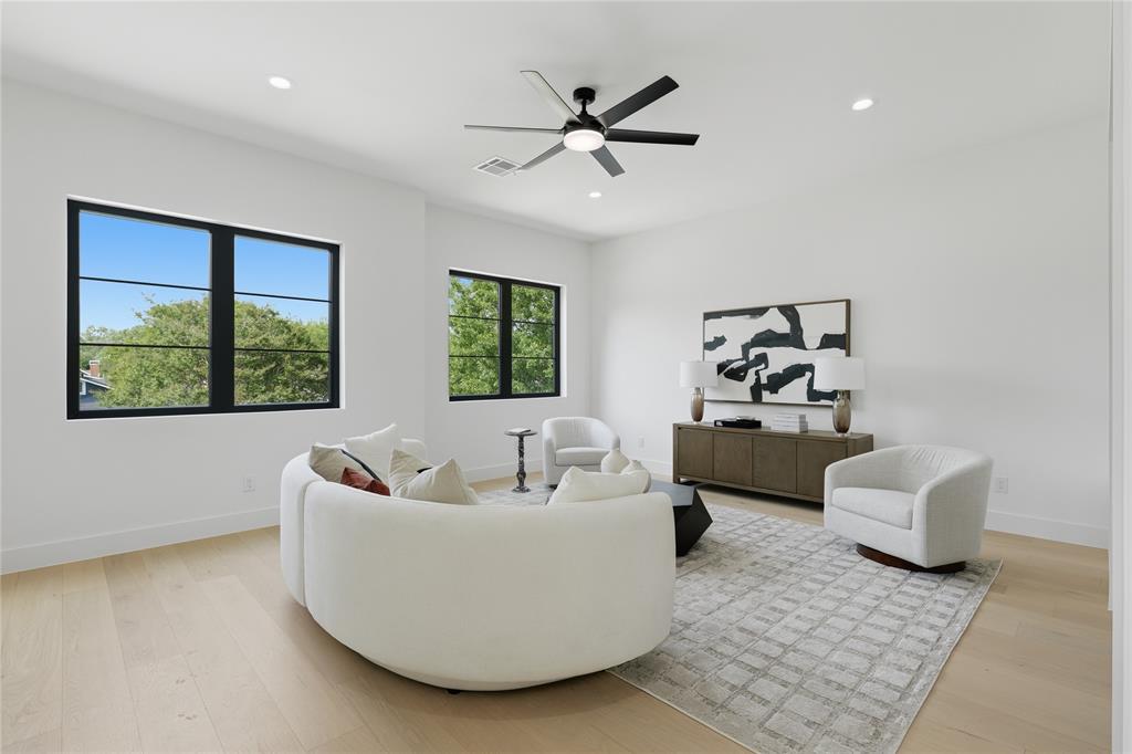 6038 Prospect Avenue Dallas, TX 75206 - Photo 29 of 40 Spacious room featuring multiple large windows with black frames, recessed lighting, and a ceiling fan