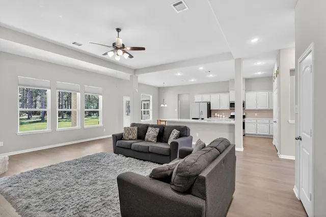 a living room with furniture and a large window