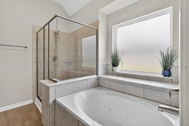 a bathroom with a bathtub and a shower