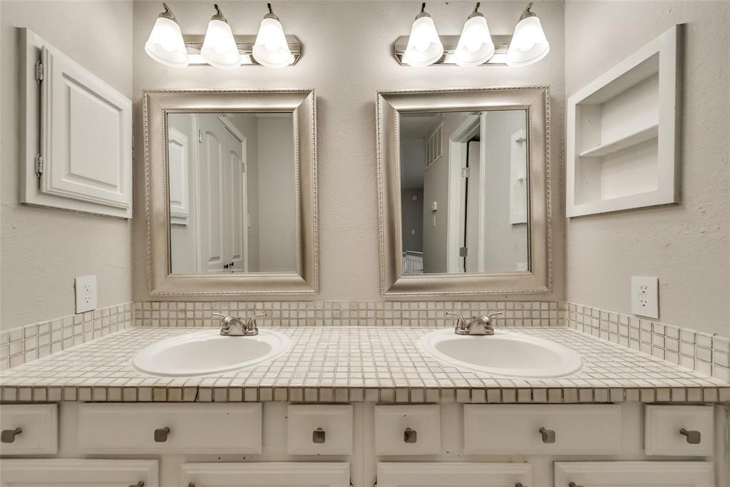 18240 Midway Road, Unit 302 Dallas, TX 75287 - Photo 20 of 33 a bathroom with double vanity sink and mirror
