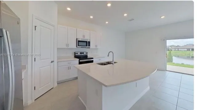 a kitchen with cabinets a sink and appliances