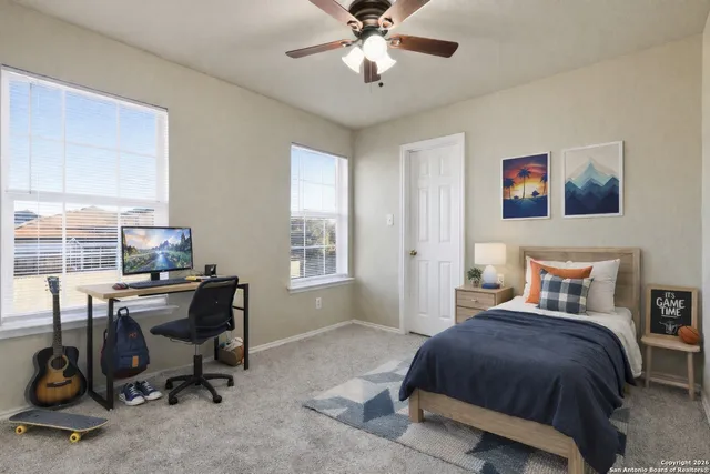 a bedroom with a bed and a desk