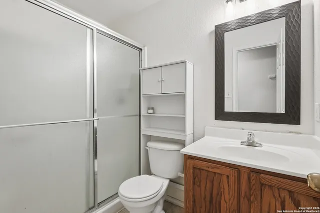 a bathroom with a sink a toilet and vanity