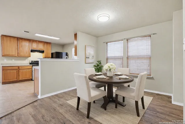 a view of a dining room with furniture and wooden floor