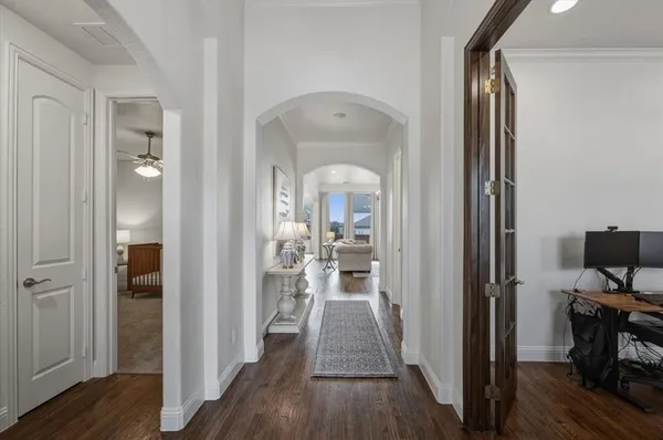 a view of a hallway view with wooden floor and furniture