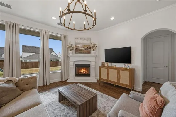 a living room with furniture a flat screen tv and a fireplace