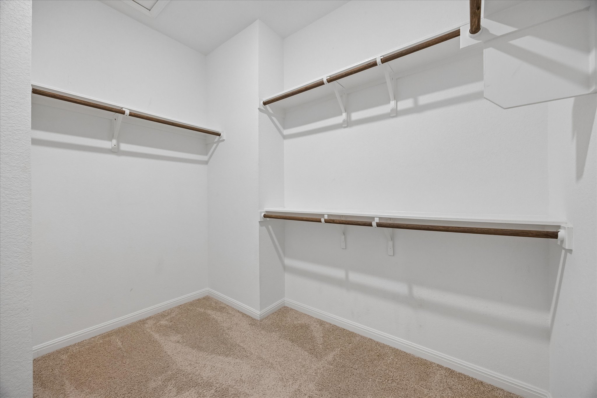 6407 Rounded Pebble Lane Buda, TX 78610 - Photo 16 of 32 Ample hanging space and shelving create an organized wardrobe solution in this well-lit closet.