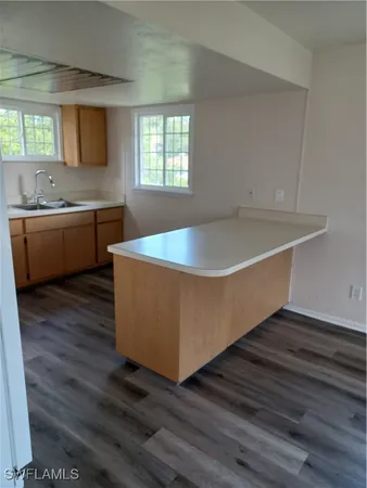a room with wooden floors and sink