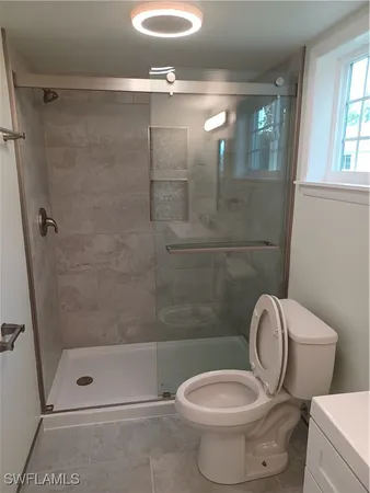 a bathroom with a toilet and a shower