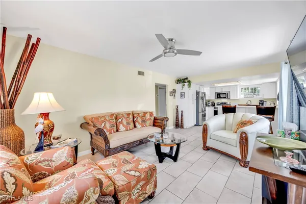 a living room with furniture and a lamp