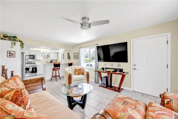 a living room with furniture and a flat screen tv