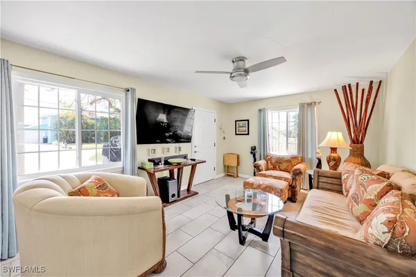 a living room with furniture fireplace and a flat screen tv