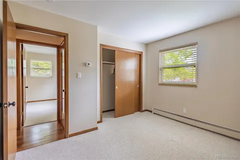 an empty room with windows and closet