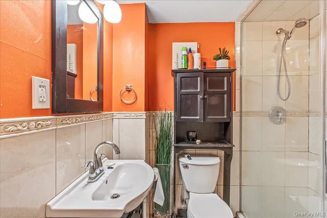 a bathroom with a toilet sink and mirror