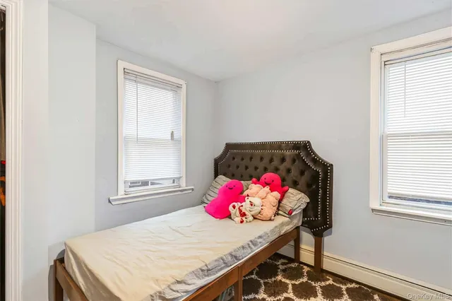 a room with a bed and a dresser in it