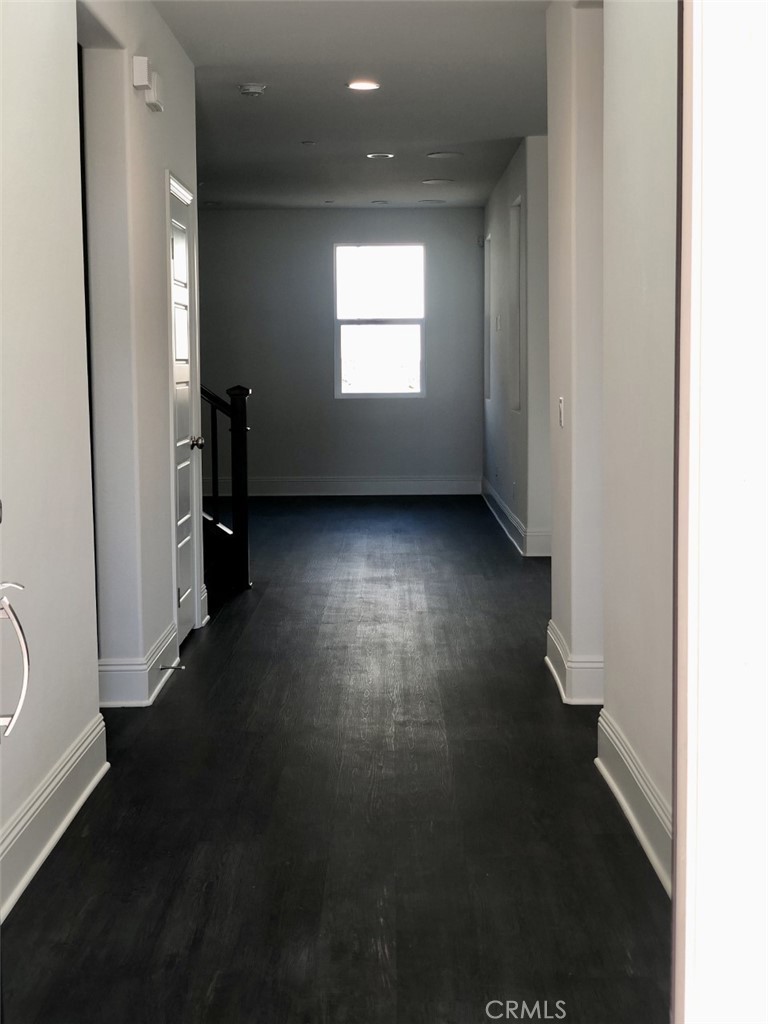39538 Verbena Way Temecula, CA 92591 - Photo 13 of 38 an empty room with wooden floor and windows