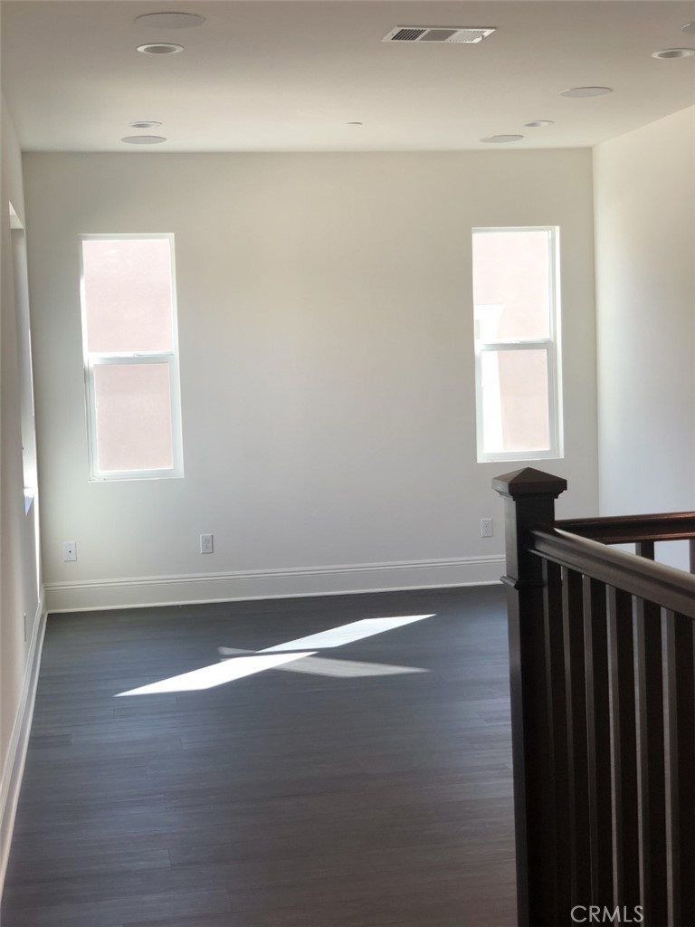 39538 Verbena Way Temecula, CA 92591 - Photo 25 of 38 an empty room with wooden floor and windows