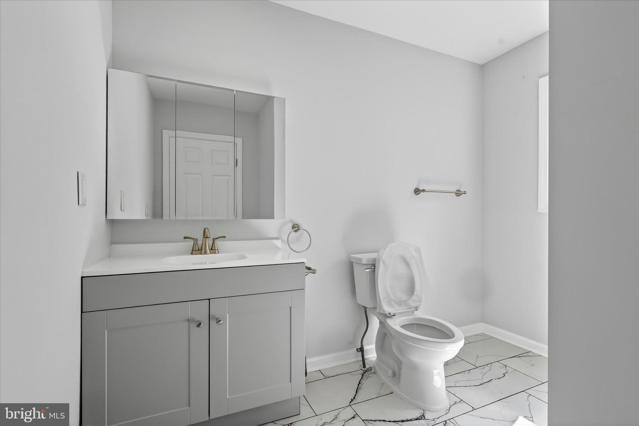 509 Lumberton Road, Unit 1 Hainesport, NJ 08036 - Photo 29 of 33 a bathroom with a toilet sink and mirror