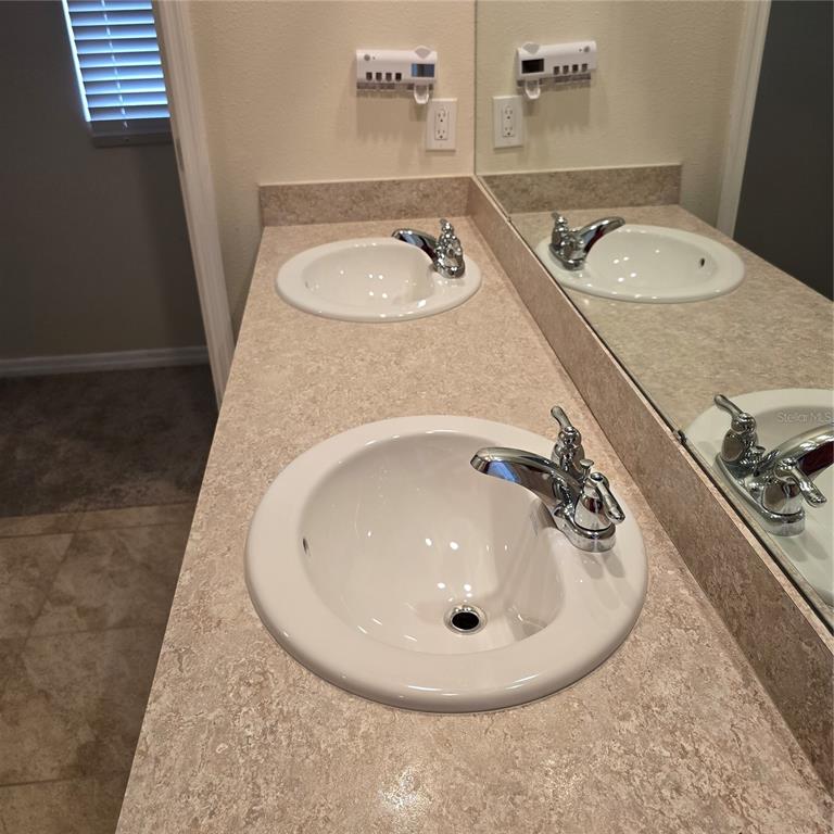 814 Sun Burst Road Winter Haven, FL 33880 - Photo 27 of 48 a bathroom with a sink and mirror
