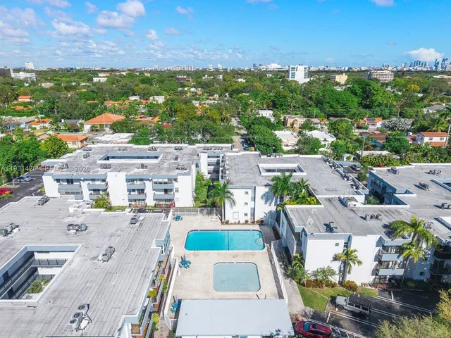 an aerial view of a house with outdoor space swimming pool and ocean view