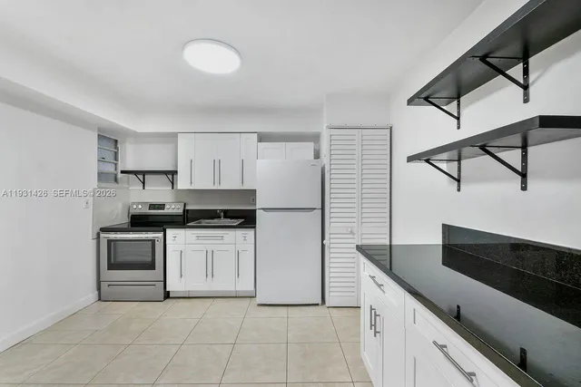 a kitchen with stainless steel appliances a sink and cabinets