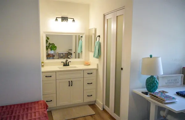 a spacious bathroom with a double vanity sink a mirror and a bathtub