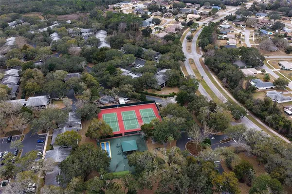an aerial view of house with swimming pool and green space