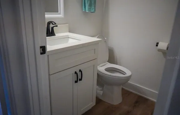 a bathroom with a toilet sink and mirror
