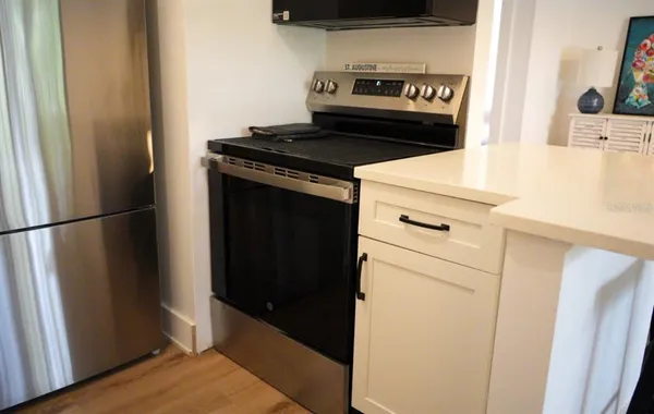 a kitchen with a stove and a refrigerator