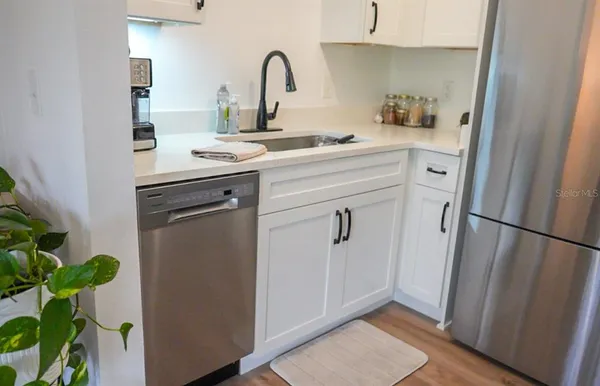 a kitchen with a refrigerator and a sink