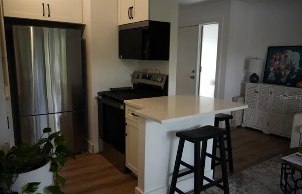 a kitchen with stainless steel appliances a refrigerator and a stove