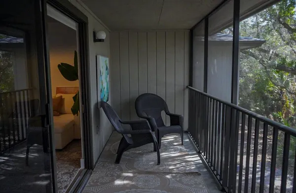 a view of balcony with furniture and city view