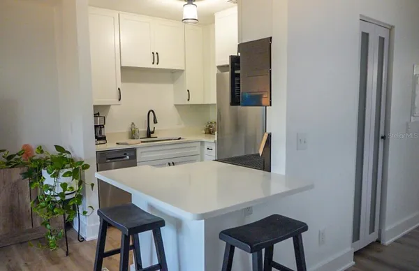a kitchen with stainless steel appliances a sink and a refrigerator