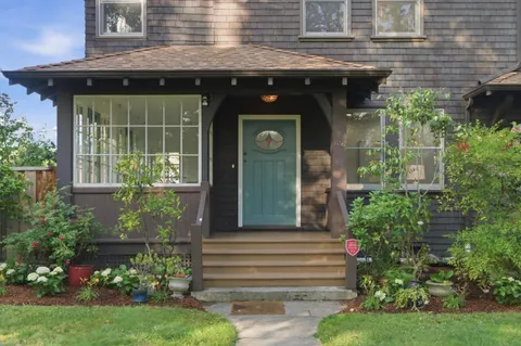a front view of a house with a garden