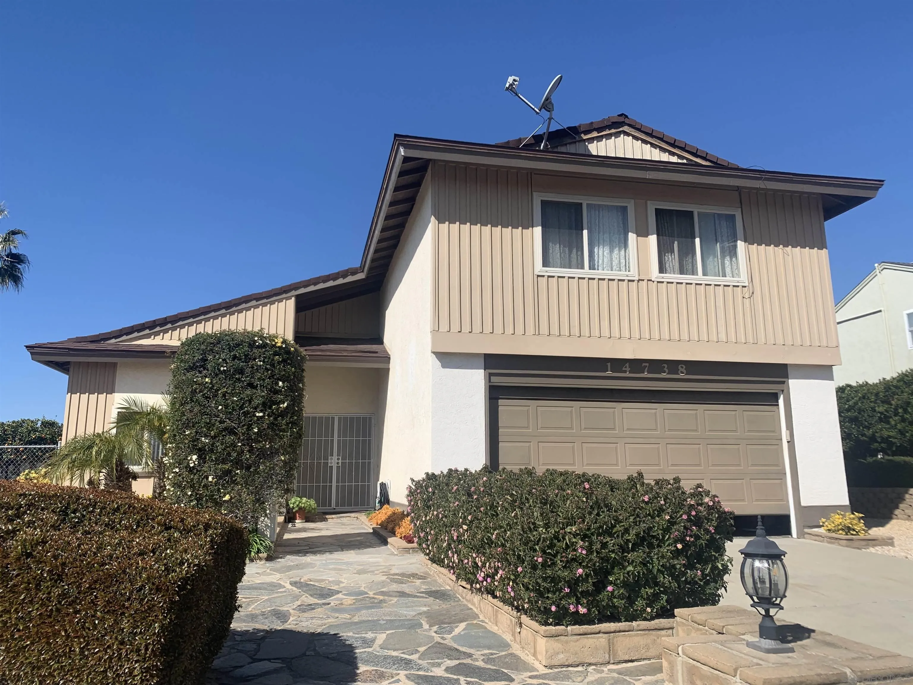 14738 Dash Way Poway, CA 92064 - Photo 1 of 4 a front view of a house with garden
