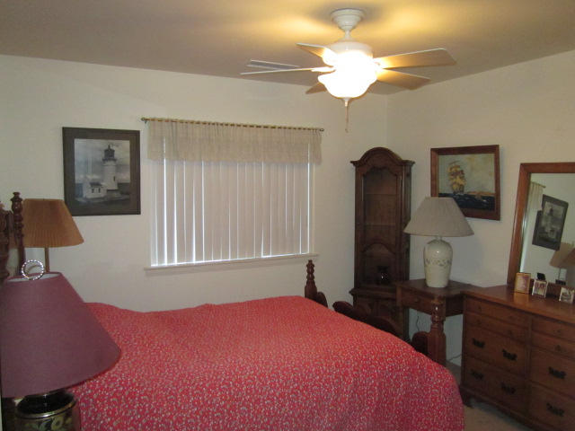 3545 East Rimrock Drive Rimrock, AZ 86335 - Photo 8 of 19 a bedroom with a bed and a chandelier